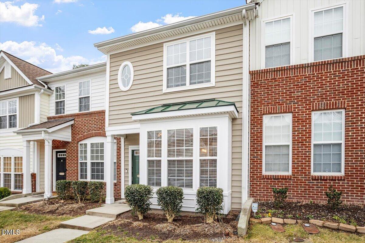 5349 Silver Moon Lane Raleigh, NC 27606 - Photo 2 of 41 front view of a brick house with a yard