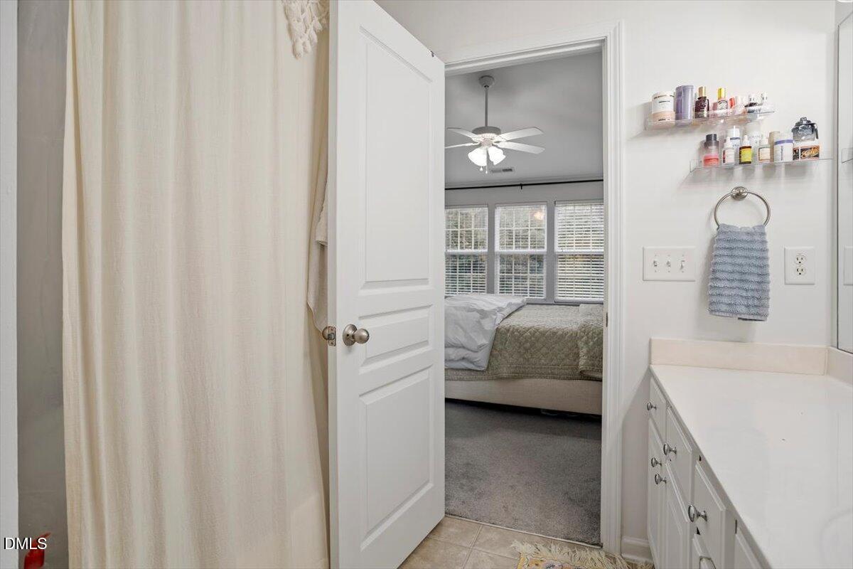 5349 Silver Moon Lane Raleigh, NC 27606 - Photo 30 of 41 a en suite bathroom with a sink and a mirror