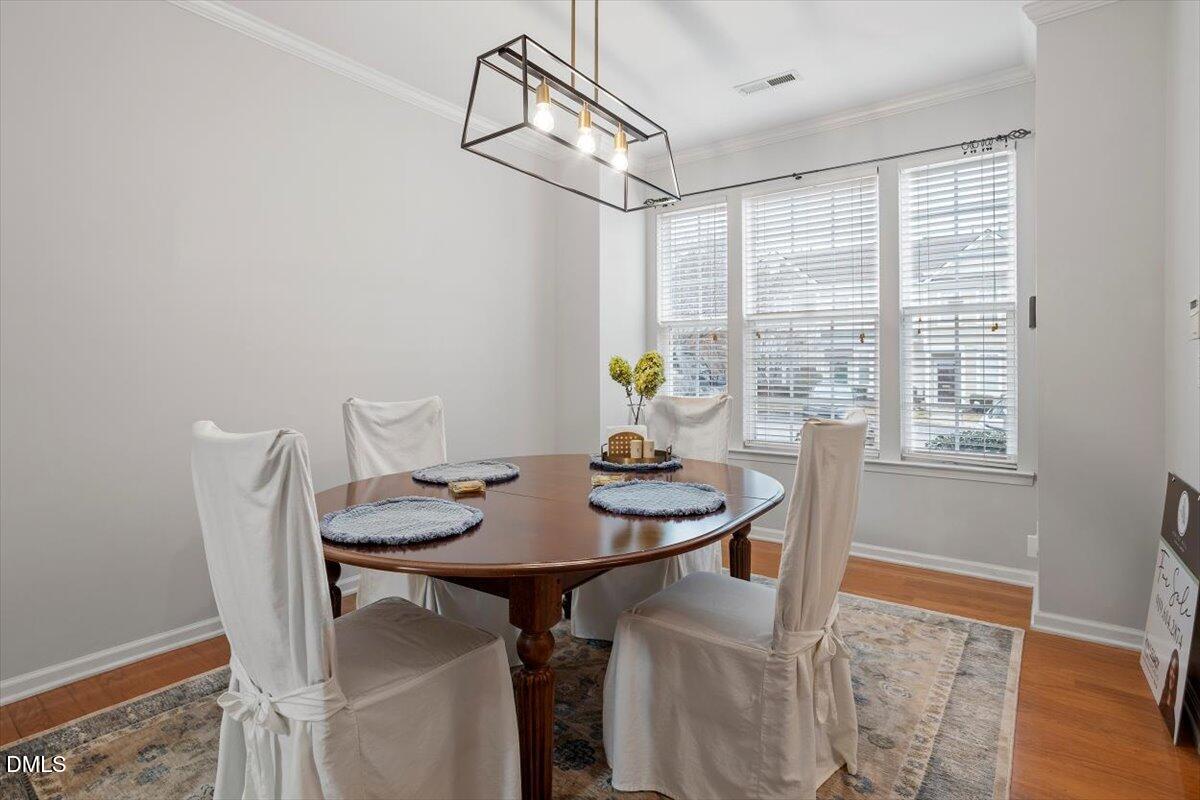 5349 Silver Moon Lane Raleigh, NC 27606 - Photo 7 of 41 a view of a dining room with furniture and wooden floor
