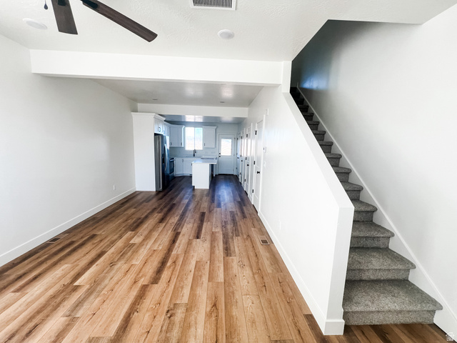 522 West 2000 South Vernal, UT 84078 - Photo 12 of 18 Unfurnished living room with dark wood-style floors and baseboards