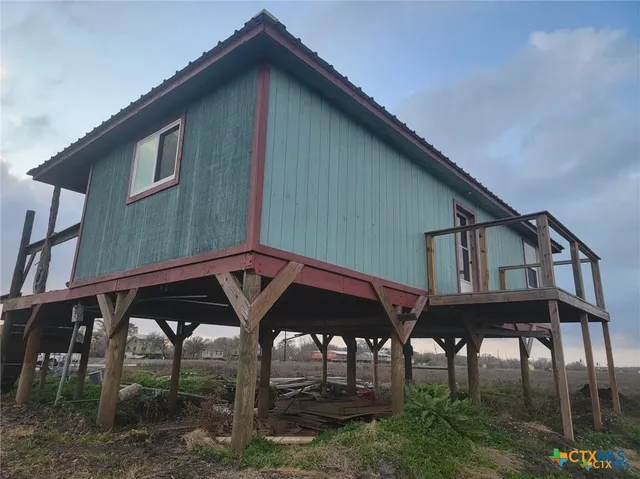 a view of a dry yard with wooden fence