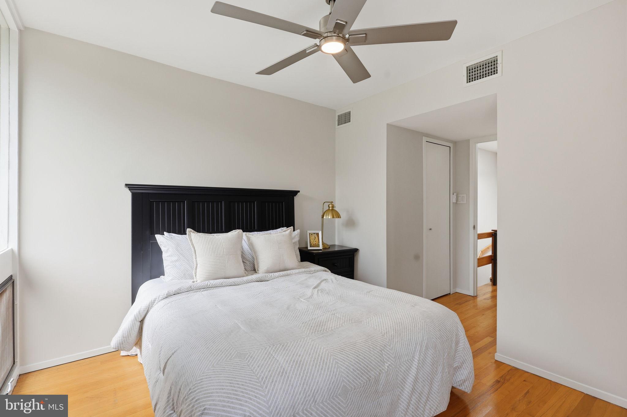 11510 Maple Ridge Road Reston, VA 20190 - Photo 24 of 43 a bedroom with a bed and ceiling fan
