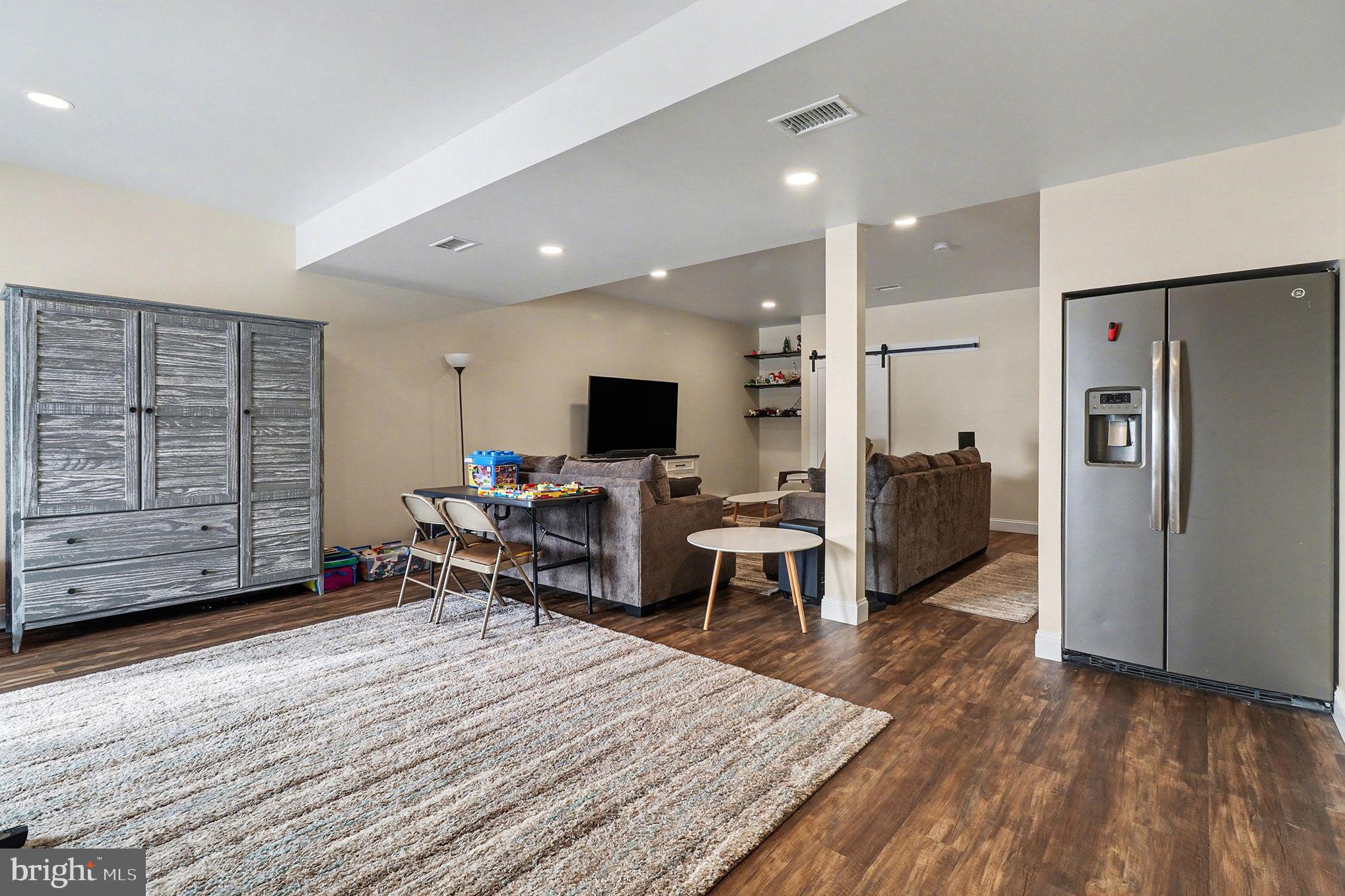 467 Hamilton Court Manheim, PA 17545 - Photo 18 of 48 a living room with furniture a flat screen tv and a refrigerator