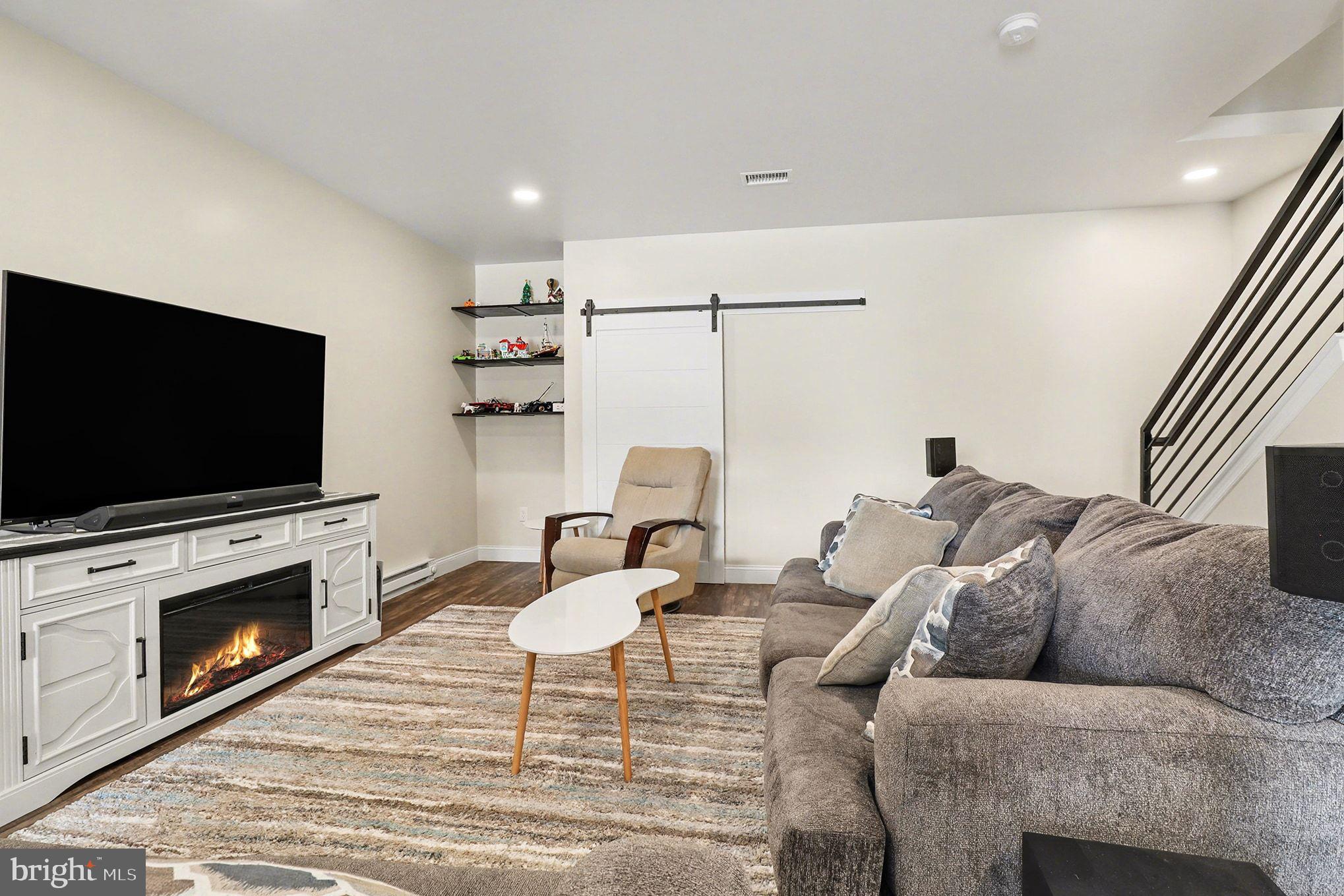 467 Hamilton Court Manheim, PA 17545 - Photo 19 of 48 a living room with furniture a flat screen tv and a fireplace