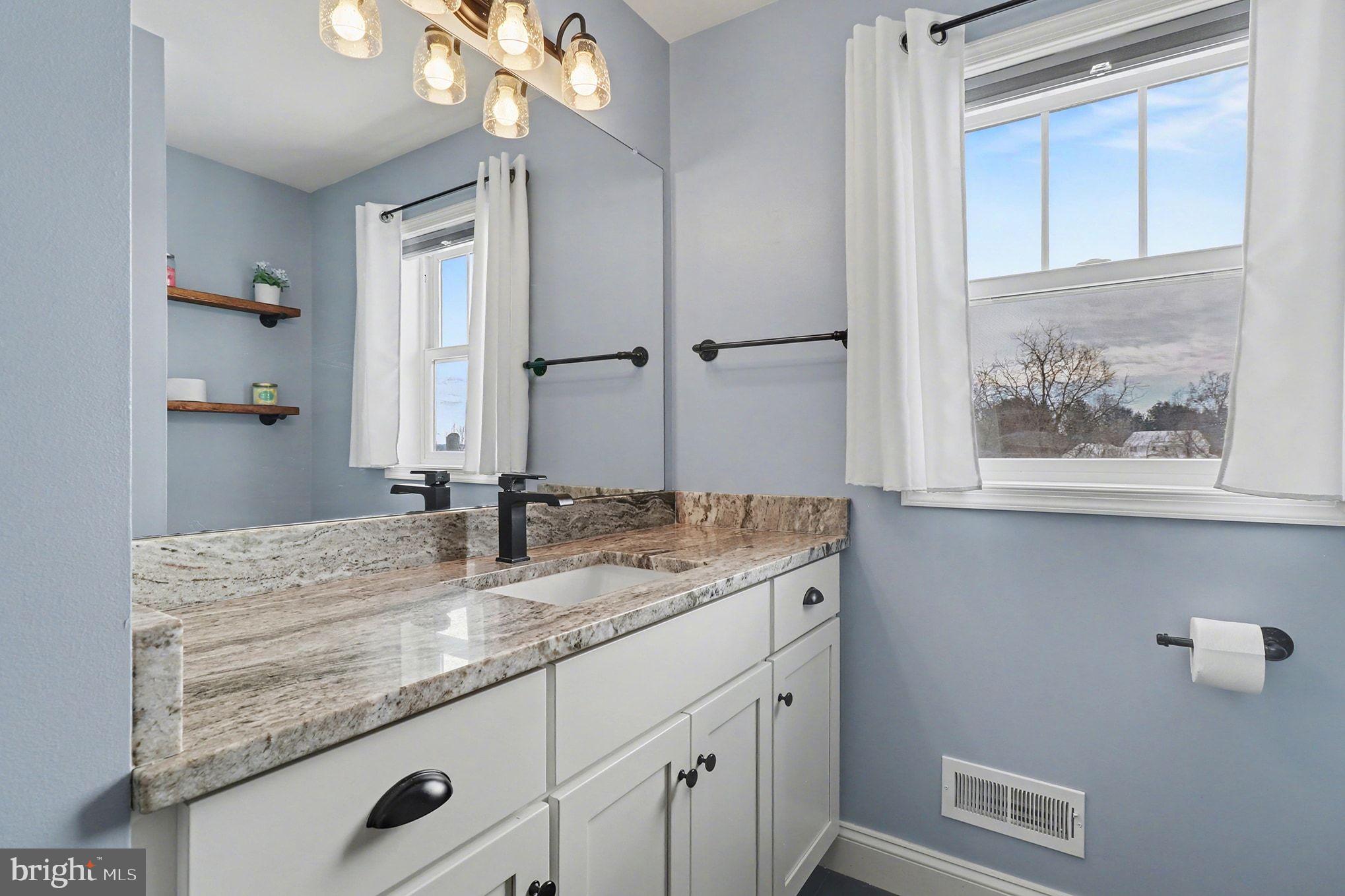 467 Hamilton Court Manheim, PA 17545 - Photo 33 of 48 a bathroom with a granite countertop sink a large mirror and vanity