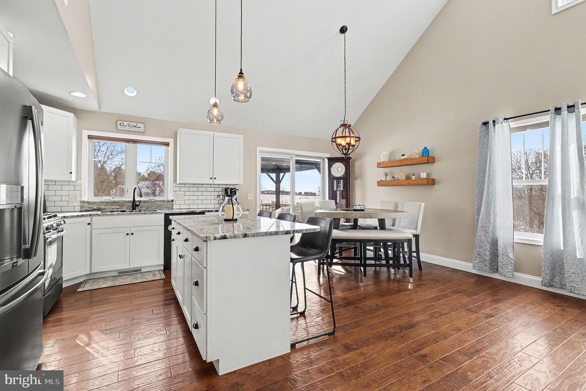467 Hamilton Court Manheim, PA 17545 - Photo 8 of 48 a living room with stainless steel appliances kitchen island a dining table chairs and a large window