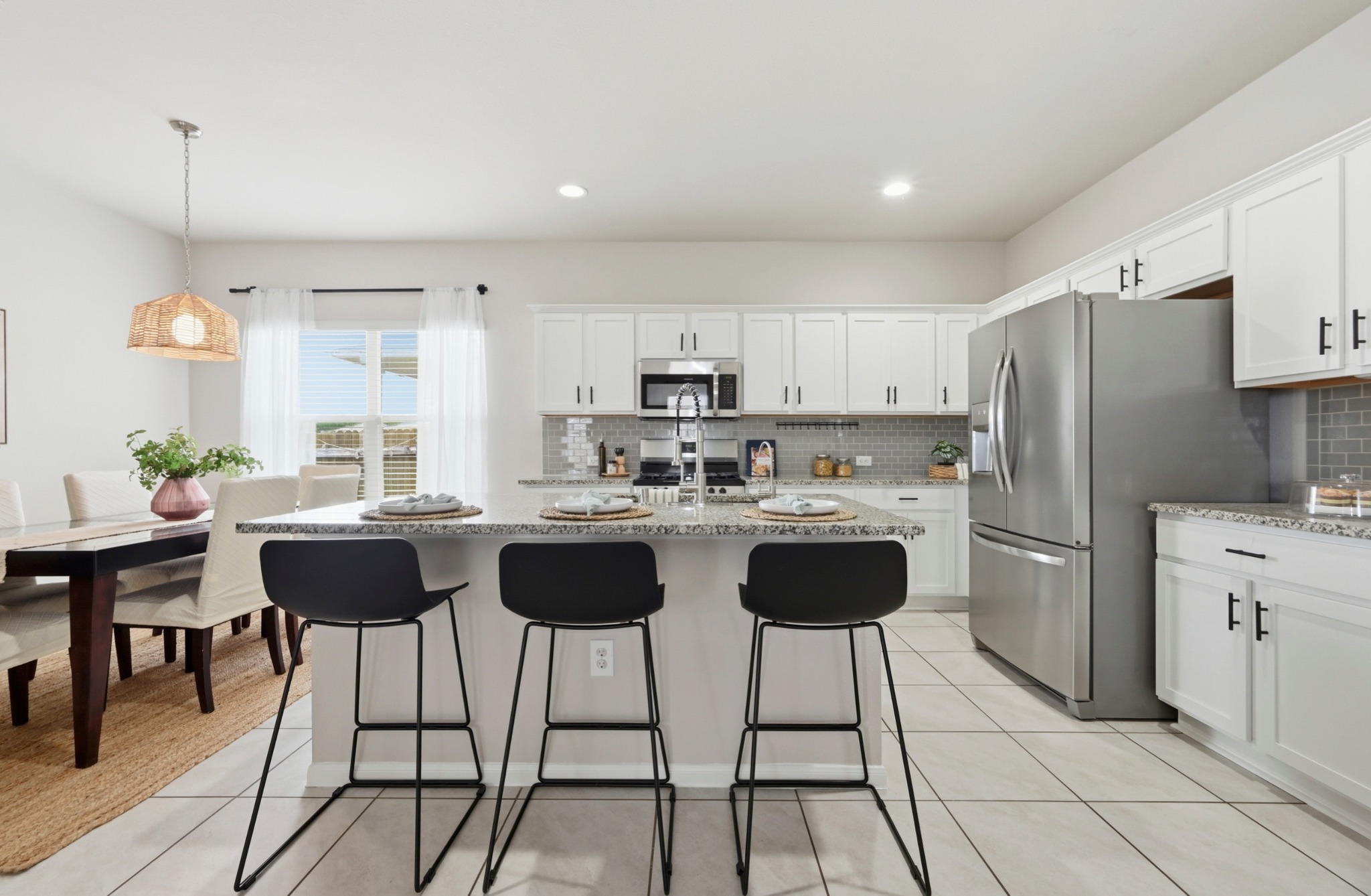9716 Baden Lane Austin, TX 78754 - Photo 12 of 30 a kitchen with a dining table chairs and a refrigerator