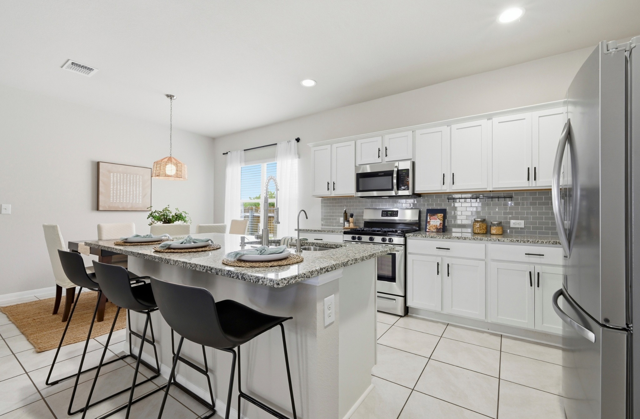 9716 Baden Lane Austin, TX 78754 - Photo 13 of 30 a kitchen with stainless steel appliances kitchen island granite countertop a sink and cabinets