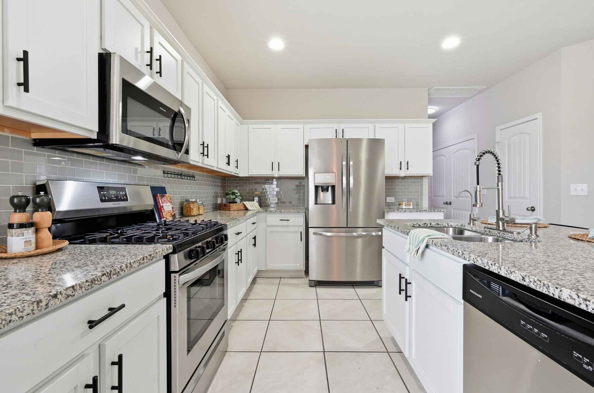 9716 Baden Lane Austin, TX 78754 - Photo 15 of 30 a kitchen with stainless steel appliances granite countertop a stove refrigerator sink and microwave