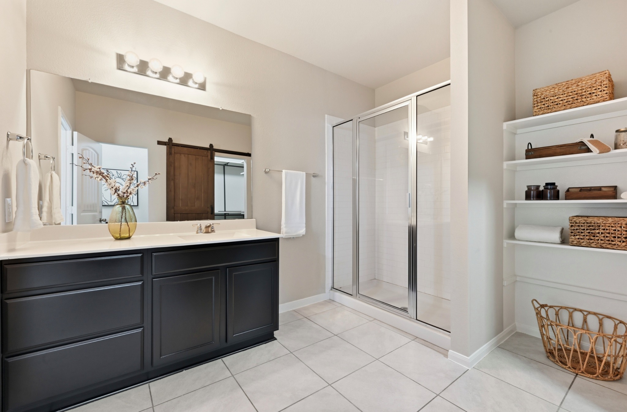 9716 Baden Lane Austin, TX 78754 - Photo 19 of 30 a spacious bathroom with a double vanity sink and a mirror