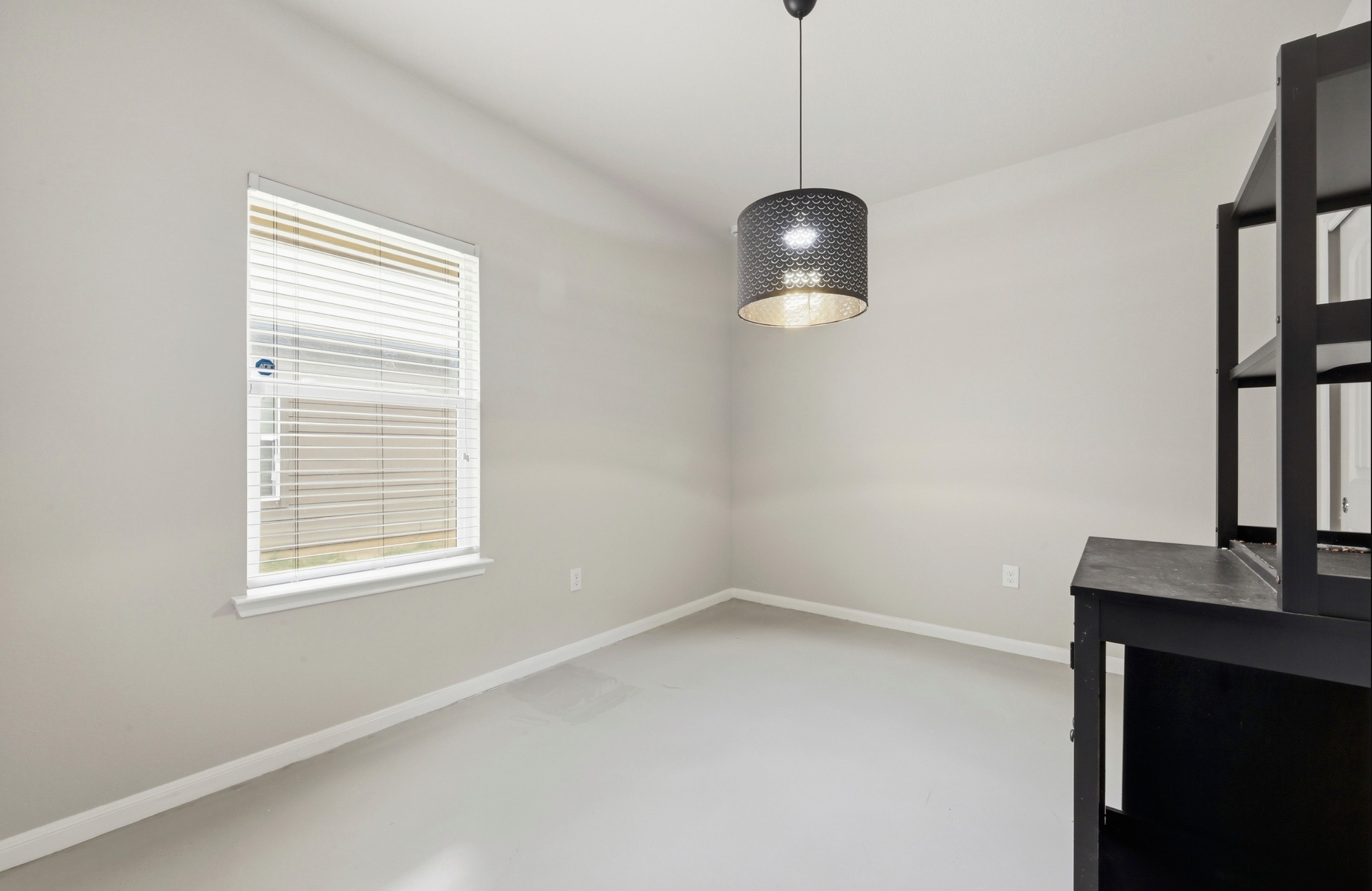 9716 Baden Lane Austin, TX 78754 - Photo 25 of 30 a view of an empty room with a window and wooden floor
