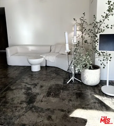 a living room with furniture a flowers and a chandelier