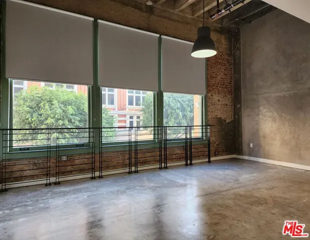 an empty room with sliding door and wooden floor