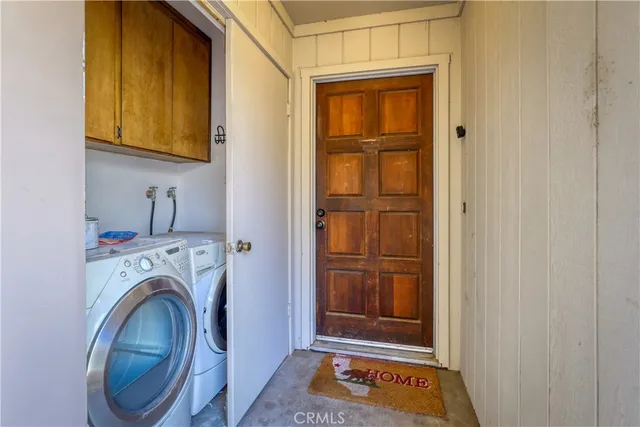 a view of front door with washer and dryer