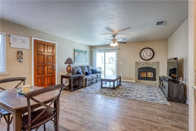 a living room with furniture a fireplace and a window