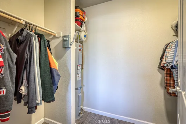 a view of walk in closet with clothes and shoes