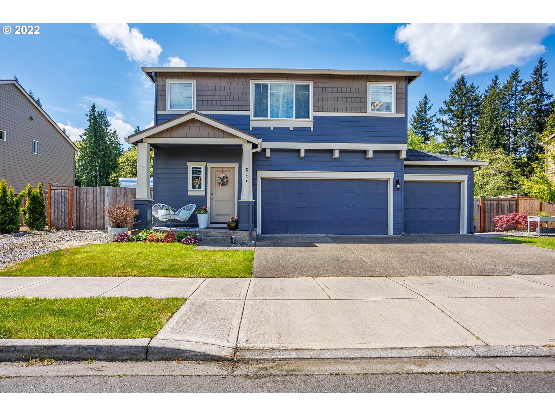 2732 South Red Tail Loop Ridgefield, WA 98642 - Photo 2 of 28 a front view of a house with a yard and a garage