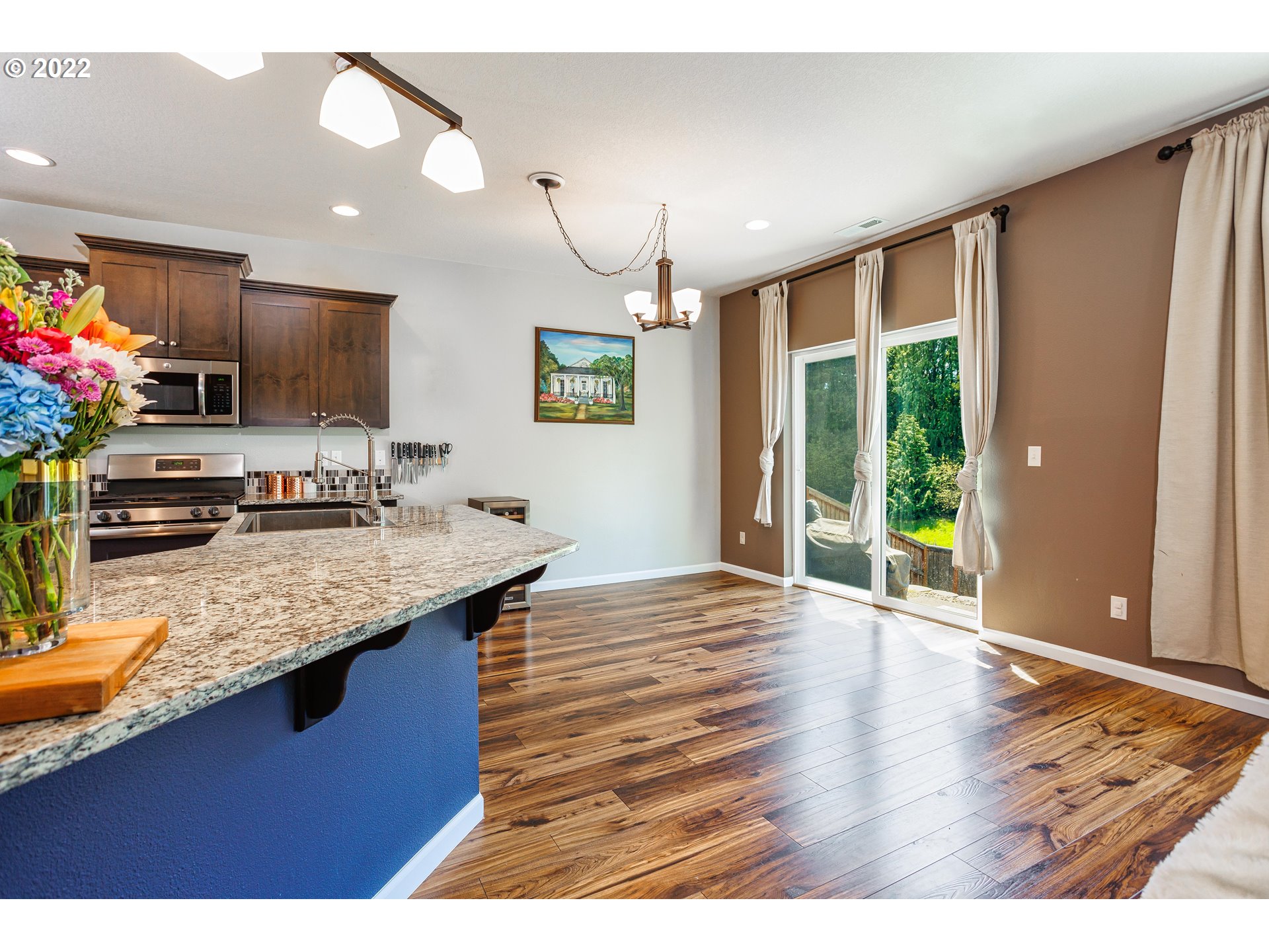 2732 South Red Tail Loop Ridgefield, WA 98642 - Photo 6 of 28 a kitchen with kitchen island granite countertop a sink cabinets and wooden floor