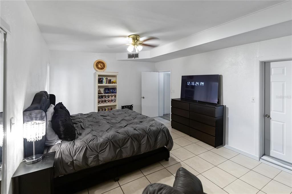 4303 Anderson Road Orlando, FL 32812 - Photo 14 of 47 a bedroom with a bed and a chandelier