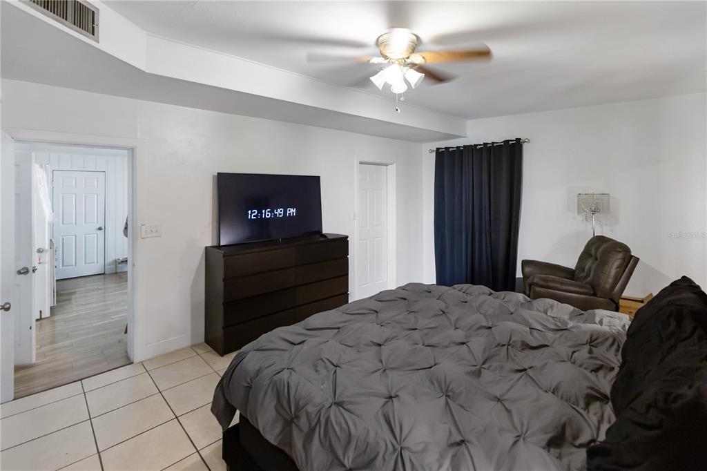 4303 Anderson Road Orlando, FL 32812 - Photo 15 of 47 a bedroom with a bed and a chandelier