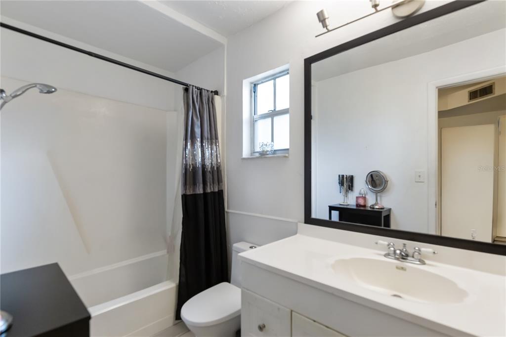 4303 Anderson Road Orlando, FL 32812 - Photo 17 of 47 a bathroom with a sink a toilet and shower