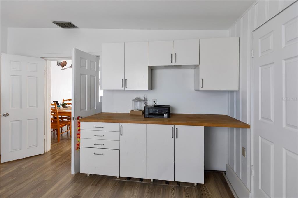 4303 Anderson Road Orlando, FL 32812 - Photo 23 of 47 a kitchen with white cabinets and sink