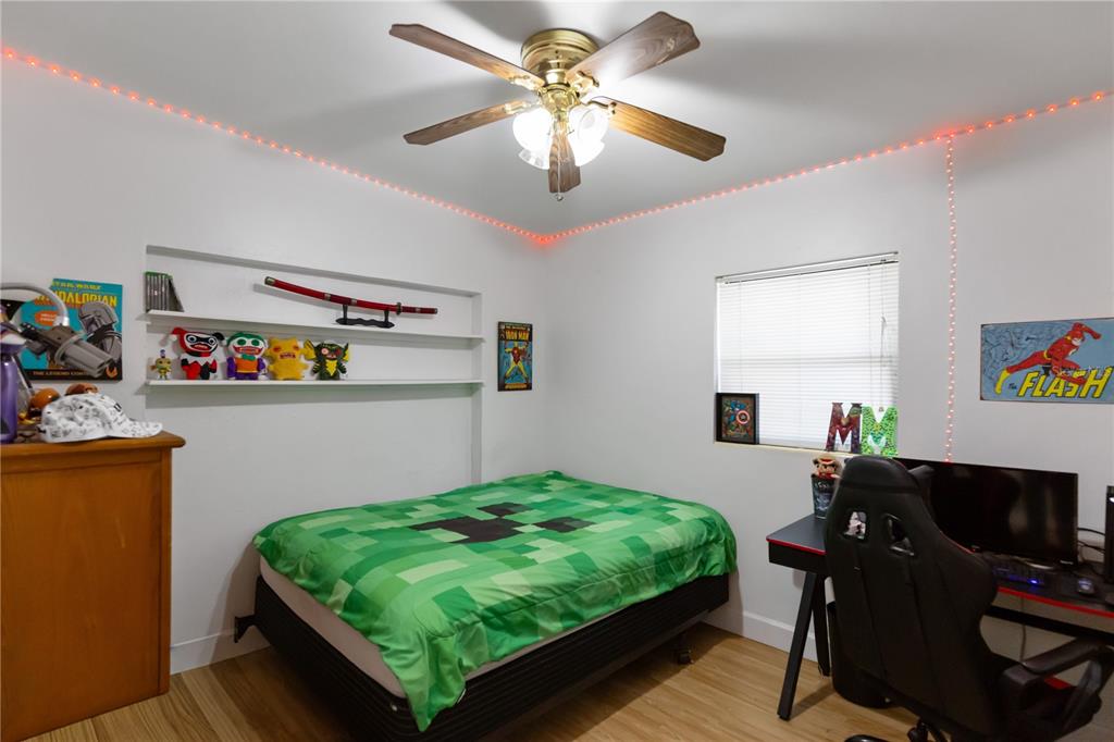 4303 Anderson Road Orlando, FL 32812 - Photo 26 of 47 a bedroom with a bed and a chandelier