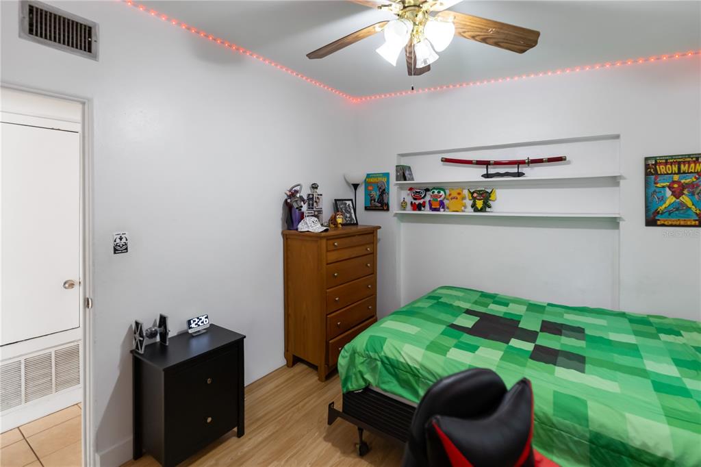 4303 Anderson Road Orlando, FL 32812 - Photo 27 of 47 a bedroom with a bed and wooden floor