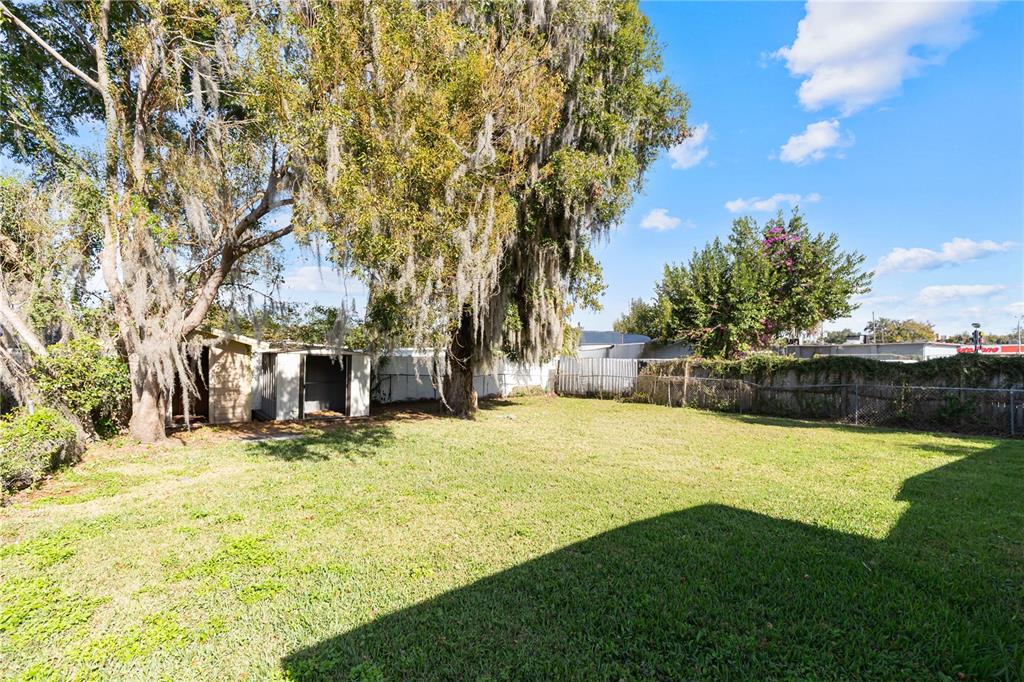 4303 Anderson Road Orlando, FL 32812 - Photo 40 of 47 a swimming pool with trees in the background
