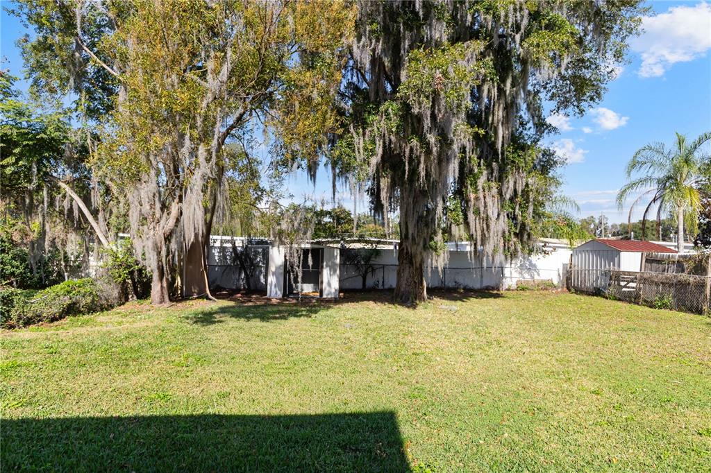 4303 Anderson Road Orlando, FL 32812 - Photo 45 of 47 a view of a swimming pool with an outdoor seating and a yard