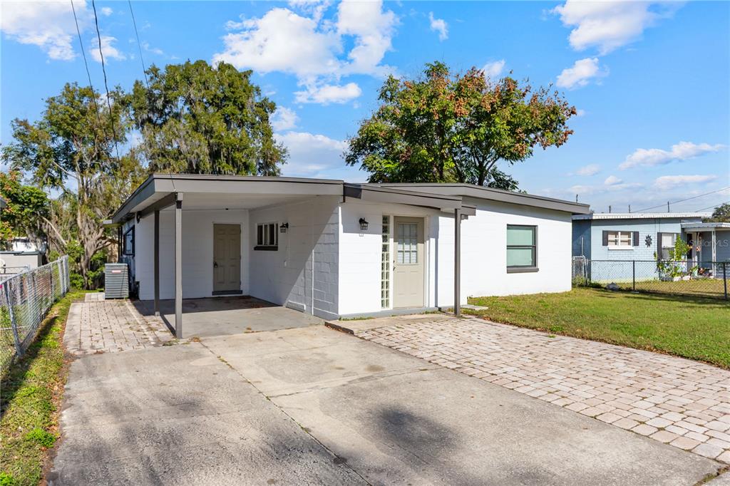 4303 Anderson Road Orlando, FL 32812 - Photo 46 of 47 a view of a house with a yard and potted plants