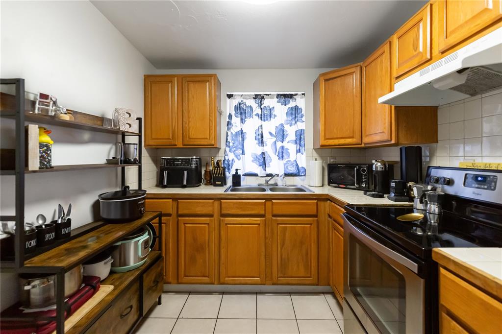 4303 Anderson Road Orlando, FL 32812 - Photo 5 of 47 a kitchen with stainless steel appliances granite countertop a sink stove and cabinets