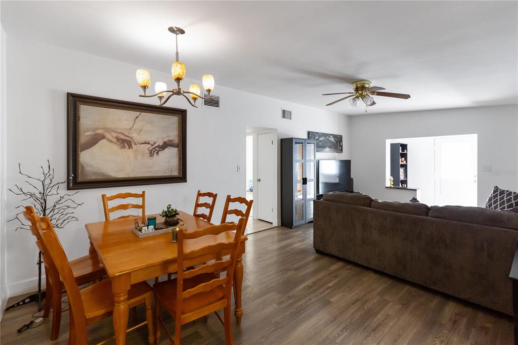 4303 Anderson Road Orlando, FL 32812 - Photo 9 of 47 a living room with furniture a dining table a lamp and a chandelier