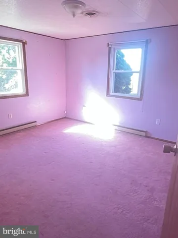 an empty room with furniture and a fireplace