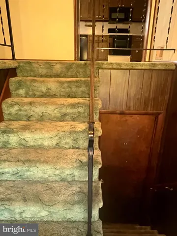 a kitchen with stainless steel appliances granite countertop a refrigerator a stove and a sink