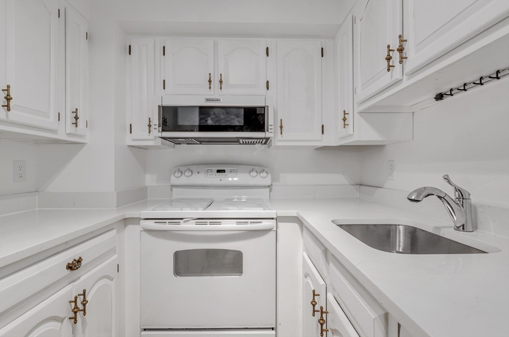 357 Commercial Street, Unit 219 Boston, MA 02109 - Photo 2 of 16 a view of a kitchen with white cabinets