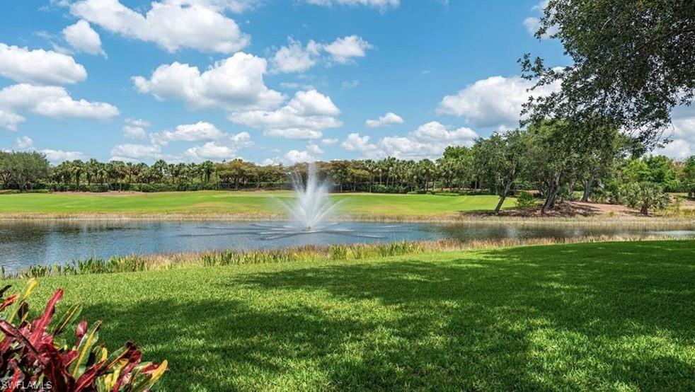 15532 Monterosso Lane, Unit 102 Naples, FL 34110 - Photo 1 of 49 a view of a lake with houses in the back