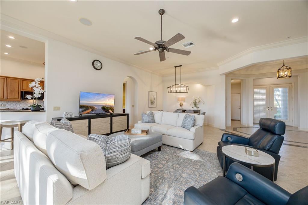 15532 Monterosso Lane, Unit 102 Naples, FL 34110 - Photo 13 of 49 a living room with furniture and a flat screen tv