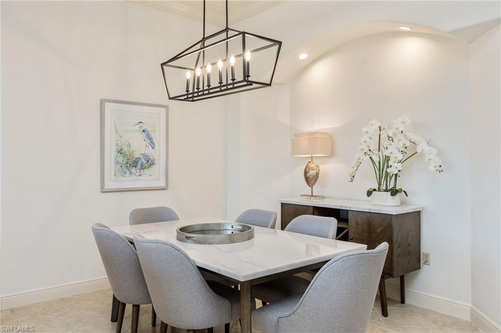 15532 Monterosso Lane, Unit 102 Naples, FL 34110 - Photo 15 of 49 a view of a dining room with furniture and chandelier