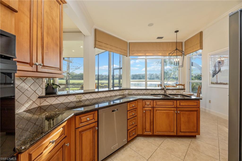 15532 Monterosso Lane, Unit 102 Naples, FL 34110 - Photo 18 of 49 a kitchen with a sink stove and cabinets