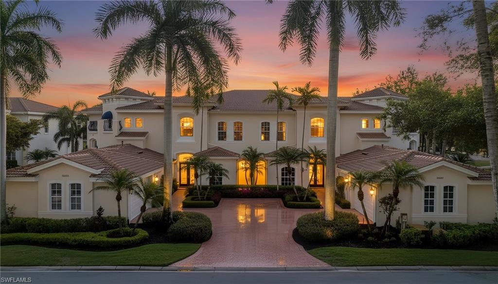 15532 Monterosso Lane, Unit 102 Naples, FL 34110 - Photo 2 of 49 a front view of a house with a garden