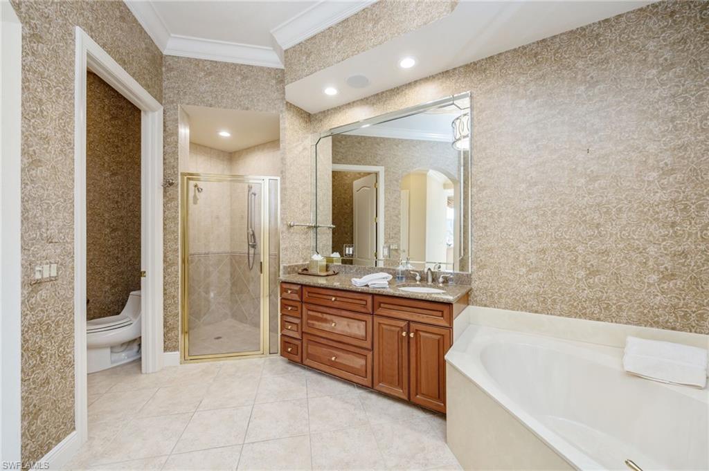 15532 Monterosso Lane, Unit 102 Naples, FL 34110 - Photo 26 of 49 a spacious bathroom with a tub sink shower and mirror