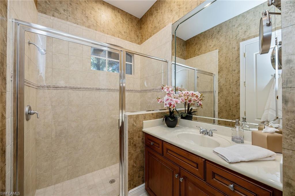 15532 Monterosso Lane, Unit 102 Naples, FL 34110 - Photo 28 of 49 a bathroom with a sink and a mirror