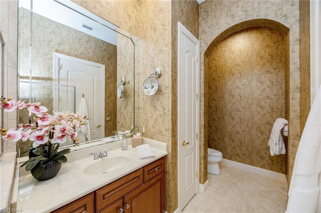 15532 Monterosso Lane, Unit 102 Naples, FL 34110 - Photo 29 of 49 a bathroom with a sink a toilet and shower