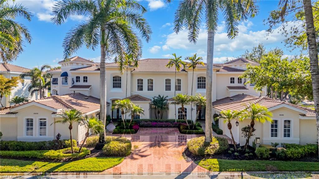 15532 Monterosso Lane, Unit 102 Naples, FL 34110 - Photo 3 of 49 a front view of multiple houses with yard