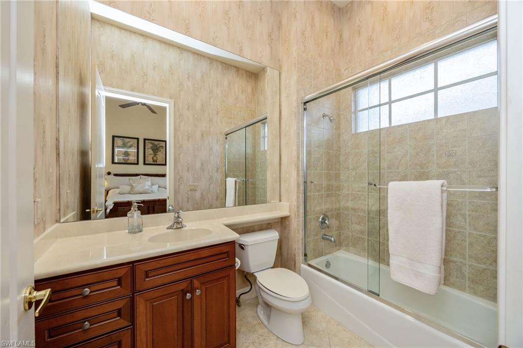 15532 Monterosso Lane, Unit 102 Naples, FL 34110 - Photo 31 of 49 a bathroom with a sink a toilet and shower