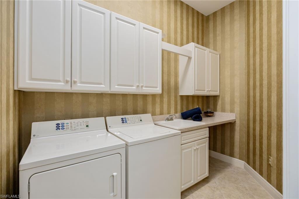 15532 Monterosso Lane, Unit 102 Naples, FL 34110 - Photo 32 of 49 a utility room with dryer and washer