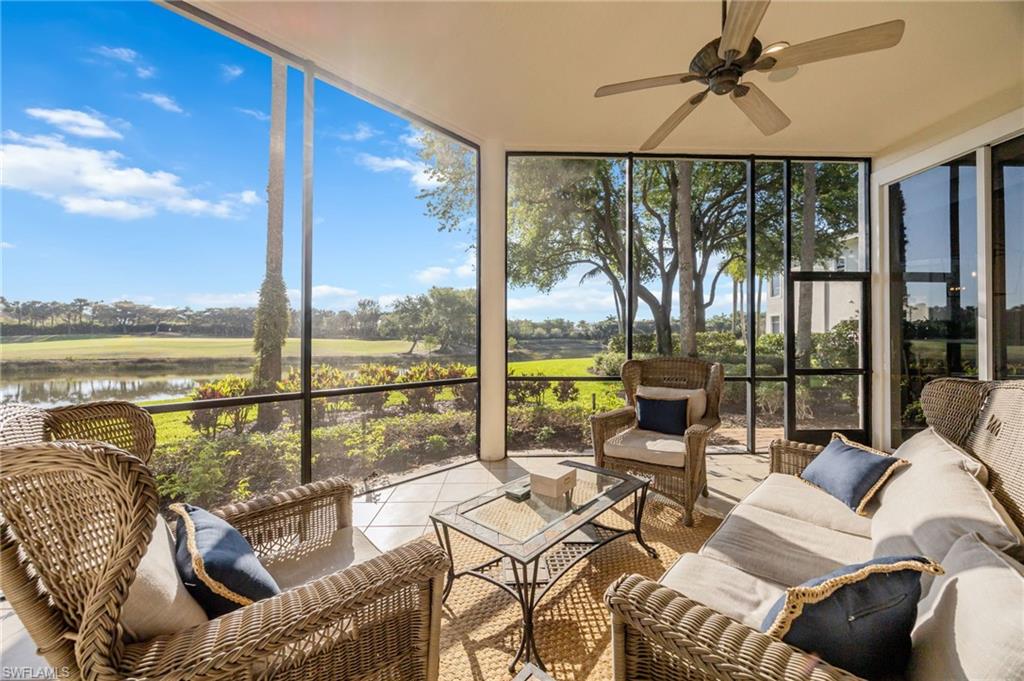 15532 Monterosso Lane, Unit 102 Naples, FL 34110 - Photo 33 of 49 a living room with furniture and floor to ceiling windows