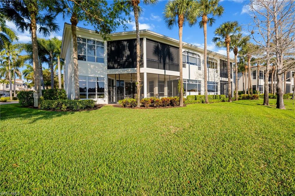 15532 Monterosso Lane, Unit 102 Naples, FL 34110 - Photo 35 of 49 a front view of a building with a garden