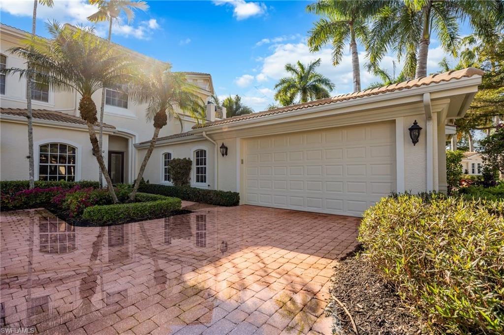 15532 Monterosso Lane, Unit 102 Naples, FL 34110 - Photo 4 of 49 a front view of a house with garden